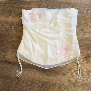 White strapless top. David’s Bridal. Pink flower detailing.